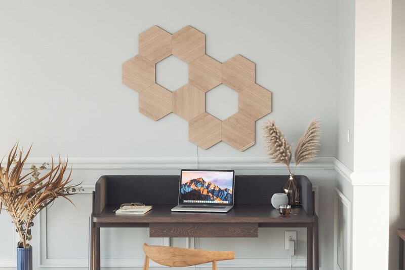 Nanoleaf Elements light tiles installed above a desk.